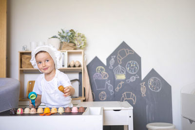 Portrait of boy playing with toy blocks on table