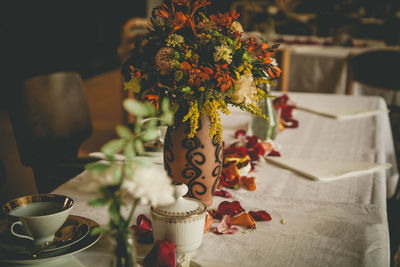 Close-up of flower vase on decorated table