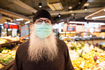 Portrait of man wearing mask in store