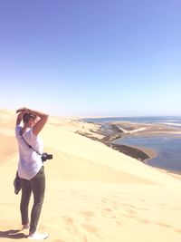 Rear view of woman standing on beach