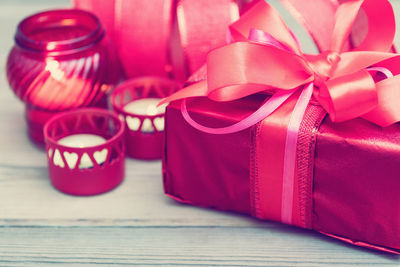 Close-up of gift with candles on table