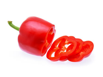 Close-up of red chili peppers against white background