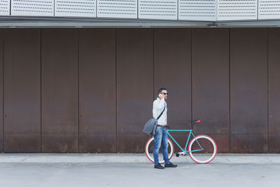 Full length of man riding bicycle