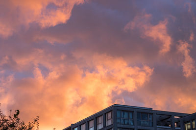 Low angle view of building against dramatic sky