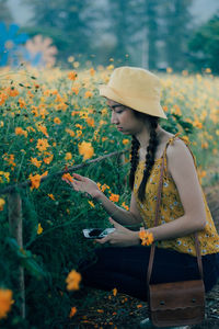 Woman looking at flowering plants