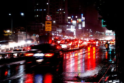 Cars on city street at night