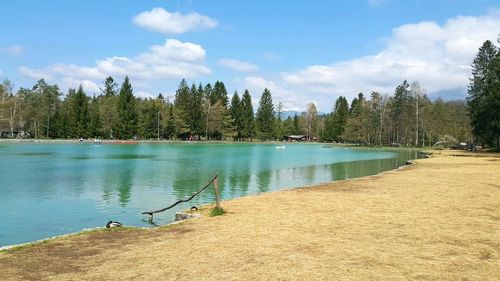 View of calm lake against cloudy sky