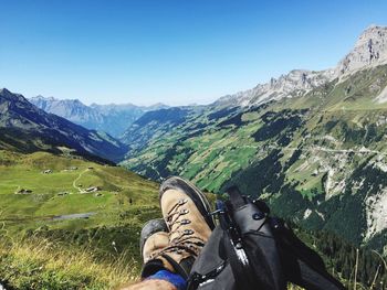 Low section of person standing on mountain