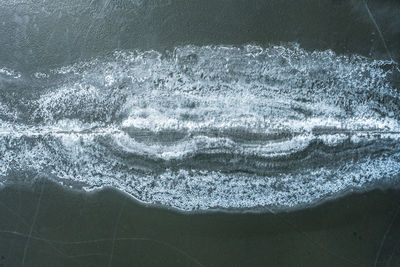 Close-up of sea waves splashing on beach