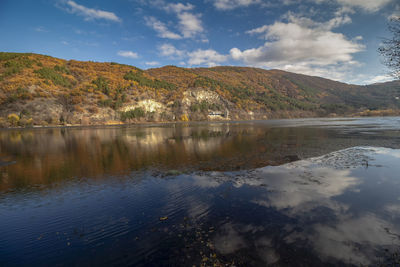 Scenic view of the lake by mountains against sky