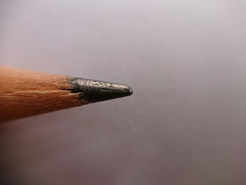 Close-up of metallic structure on table against sky