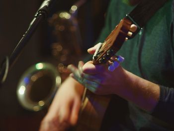 Close-up of hands playing guitar