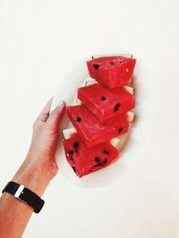 Close-up of hand holding over white background