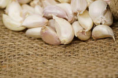 Close-up of garlics on jute