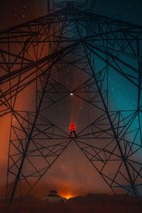 Low angle view of illuminated lamp against sky at night