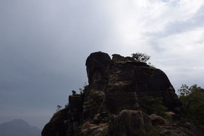 Low angle view of rock formation against sky
