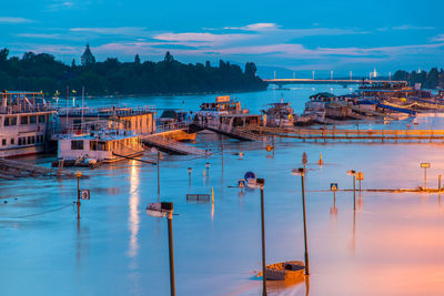 Sailboats in sea against sky at dusk