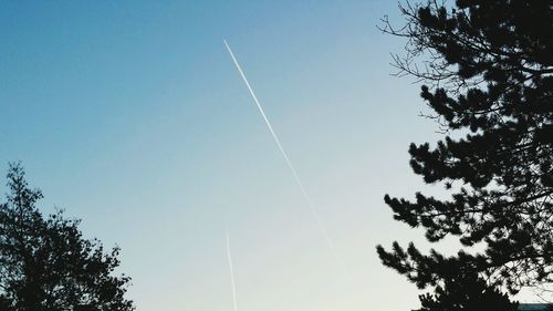 Low angle view of vapor trail against clear sky