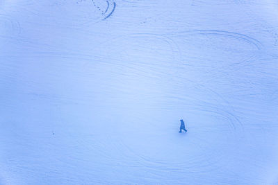 High angle view of person on snow covered land