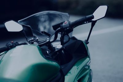 Close-up of motorcycle on road