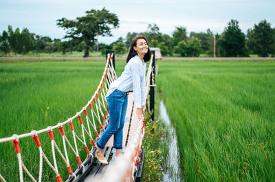 Portrait of young woman on field