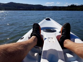 Low section of man in boat on river