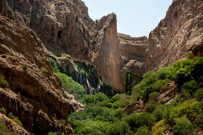 Low angle view of rock formation on mountain against sky