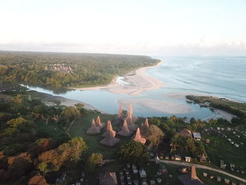 High angle view of land and sea against sky