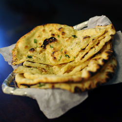 Close-up of butter naans in container
