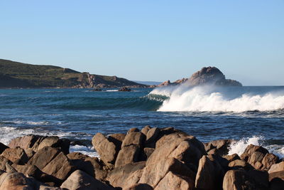 Scenic view of sea against clear blue sky