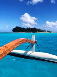 Swimming pool by sea against blue sky