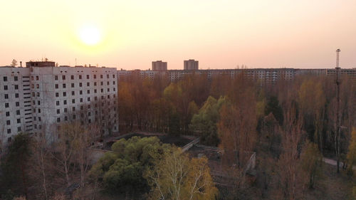 Panoramic shot of residential buildings against sky during sunset