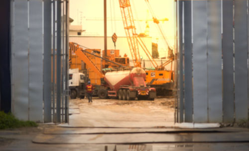 Construction site against sky during sunset