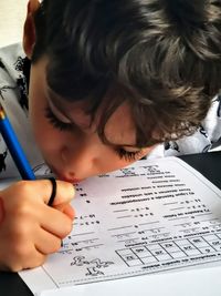 Close-up portrait of boy holding paper