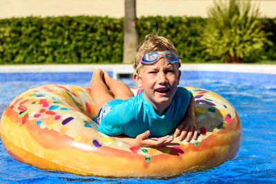 Portrait of smiling boy in swimming pool