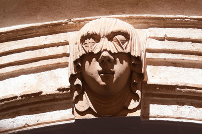 Close-up of human sculpture against wall