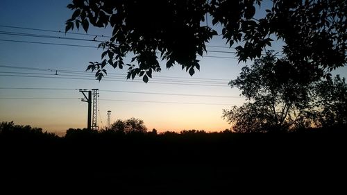 Silhouette trees against sky during sunset