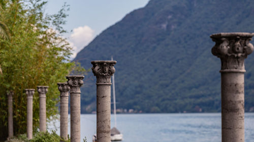 Stone structure in sea against mountain