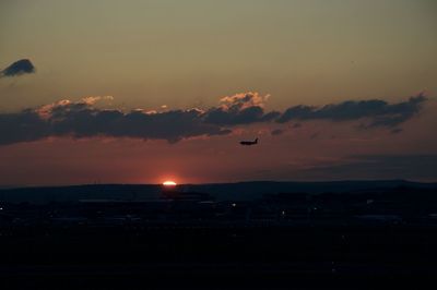 Silhouette of city at sunset