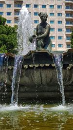 Statue of fountain in front of building