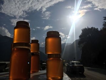 Close-up of beer bottles against sky