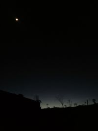 Silhouette landscape against sky at night