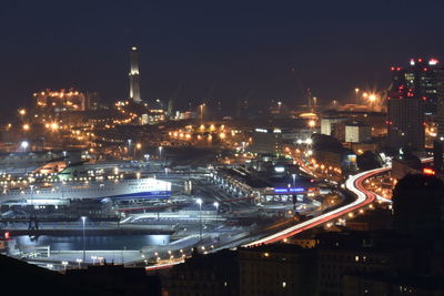 High angle view of illuminated cityscape against sky at night