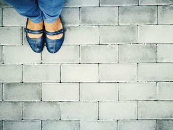 Low section of man standing on cobblestone