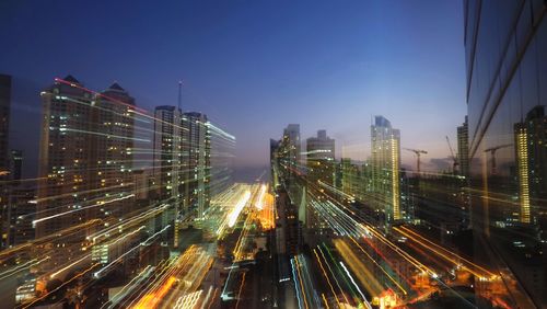 High angle view of illuminated cityscape against sky at night