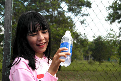 Smiling woman holding water bottle