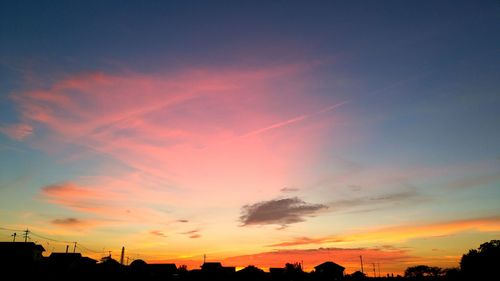 Silhouette buildings against sky during sunset