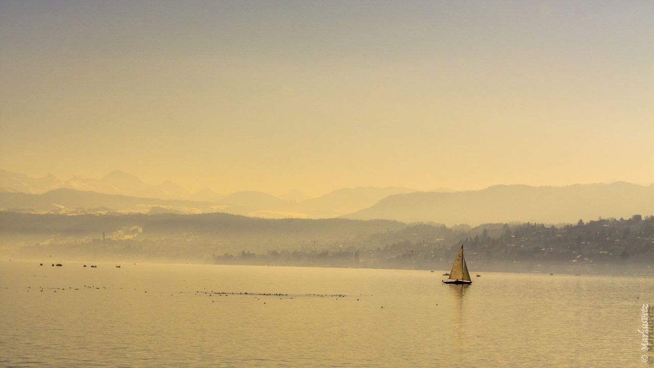 BOATS SAILING IN SEA AGAINST SKY