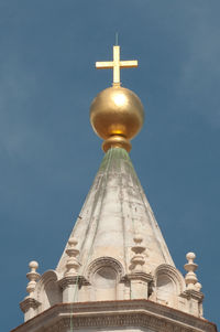Low angle view of bell tower against blue sky