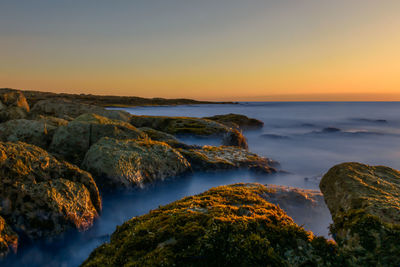 Scenic view of sea against sky at sunset